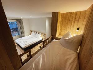 a view of a bedroom with a bed and a window at Mei-so-nett Appartement Hutegger in Schladming