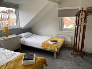 a bedroom with two beds and a window at Hope Corner in Filey