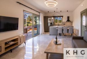 a living room with a large tv and a kitchen at Tania's Villa in Dorizata village! in Dhorizáta