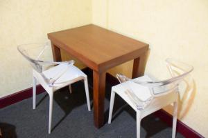 a wooden table and two chairs next to a table at Janara Two in Kurunegala