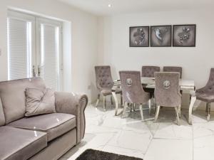a living room with a couch and a table and chairs at The Hawthorns in Seaham