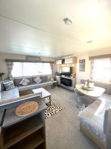 a living room with a couch and a table at Berwick Holiday Park Haven in Berwick-Upon-Tweed +19 photos