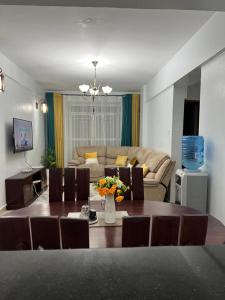 a living room with a table and a couch at Comfortplace 2 bedroom in Kericho