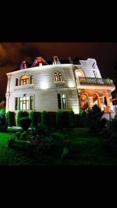 ein großes weißes Haus mit Lichtern darüber in der Unterkunft All Seasons Hotel Baku in Baku