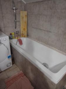 a bath tub in a bathroom with a sink at Casa Mocanu in Giurgiu