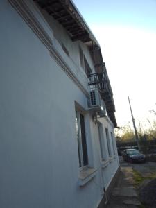 a white building with a balcony on the side of it at Casa Mocanu in Giurgiu