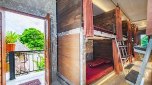 a bunk bed in a room with a window at Peanut House in Ubud