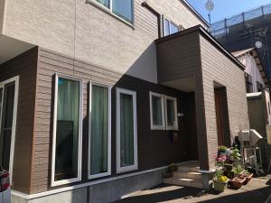 a brick house with windows on the side of it at Art Inn 24 Sapporo in Ōdōri