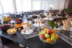 a table with bowls of fruit on top at Mercury Hotel- All Inclusive in Sunny Beach