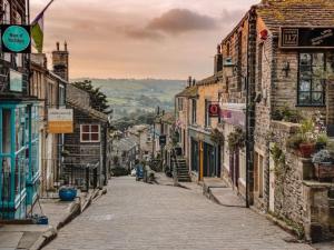 an empty street in an old town with buildings at Poppy's Place in Oakworth