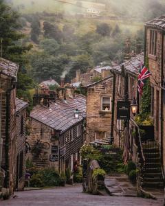 an image of a village with a flag on a street at Poppy's Place in Oakworth