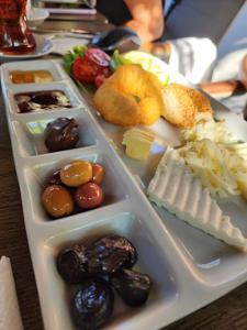 a plastic tray of food with different types of food at Benjamin Otel Gumusluk in Gumusluk