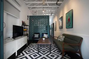 a living room with a couch and a tv at Stay SongSong Mount Erskine in George Town