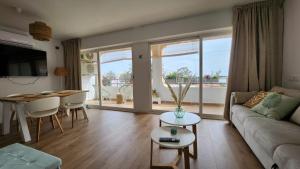 a living room with a couch and a table at Mediterranean apartment Rosas in Roses