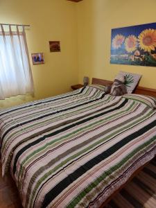 Un dormitorio con una cama grande con un animal de peluche. en Apartmaji Alenka, en Bled