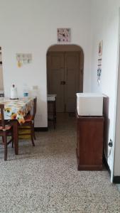 a dining room with a table and a table and a door at La casa del golfo in Gavorrano