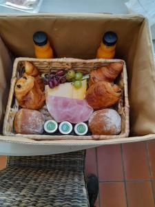 een doos gevuld met brood en gebak op een plank bij Ô ptit Zébo in Bras