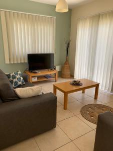 a living room with a couch and a coffee table at Villa Agnes in Ayia Napa