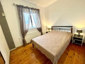 a bedroom with a large bed and a window at Villa AMIA in Áyios Spirídhon