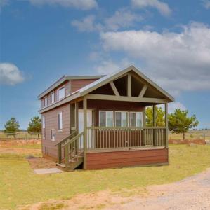 a small house with a porch on a field at 036 Tiny Home nr Grand Canyon South Rim Sleeps 8 in Valle