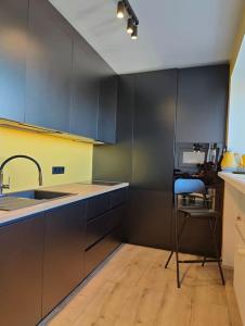 a kitchen with a sink and a chair in it at Lai Apartment in City center of Rakvere in Rakvere