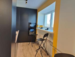 a room with two chairs and a counter and a window at Lai Apartment in City center of Rakvere in Rakvere