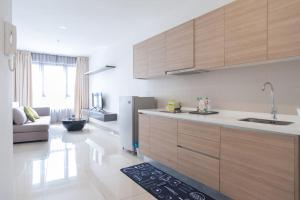 a kitchen with a sink and a refrigerator at iCity 2Bedroom Themepark, Mall Wi-Fi in Shah Alam