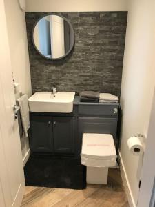 a bathroom with a sink and a mirror at Modern 3 Bed Barn Conversion in Great Urswick in Great Urswick