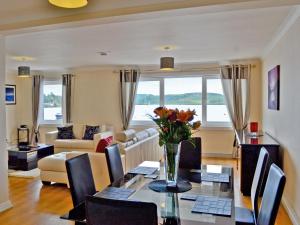 a living room with a table with a vase of flowers at Seaview in Oban