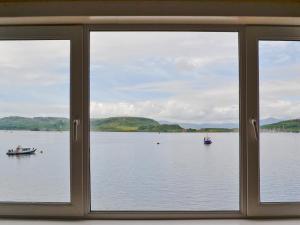 a window view of a lake with boats in it at Seaview in Oban