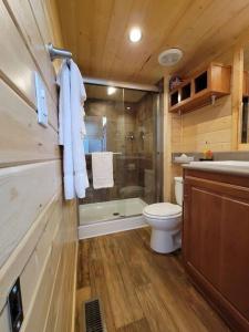 a bathroom with a toilet and a shower and a sink at 037 Tiny Home nr Grand Canyon South Rim Sleeps 8 in Valle +8 photos
