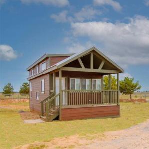 a small house with a porch on a field at 037 Tiny Home nr Grand Canyon South Rim Sleeps 8 in Valle