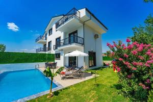 a villa with a swimming pool and a house at Rmg Villa 1 in Seydiler