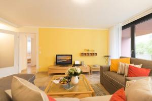 ein Wohnzimmer mit Couch und Fernseher in der Unterkunft Quartier 47, App. 07 in Bansin