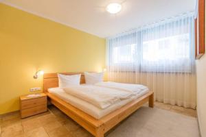 Ein Bett oder Betten in einem Zimmer der Unterkunft Quartier 47, App. 07