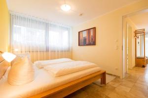 Ein Bett oder Betten in einem Zimmer der Unterkunft Quartier 47, App. 07