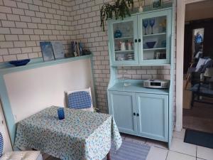 a dining room with a table and a cabinet at BARHOLM CROFT Holiday Cottage in Creetown