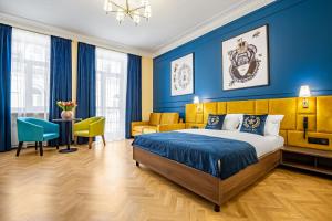 a bedroom with a king sized bed and blue walls at Queen Bee in Kyiv