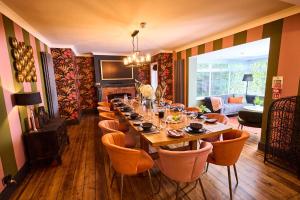 a dining room with a long table and chairs at Little Hayes, Lyndhurst in Lyndhurst