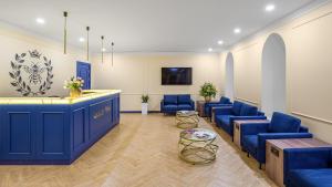 a waiting room with blue chairs and a counter at Queen Bee in Kyiv