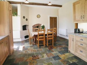 a kitchen and dining room with a table and chairs at Armswell House in Ansty