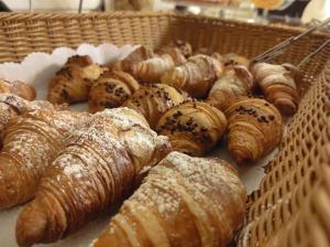 a basket of pastries and croissants on a table at Hotel Palace in Levanto