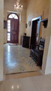 a large room with a door and a tile floor at Warda Accommodation in Xewkija