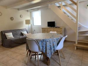 a living room with a table and a couch at Maison de pêcheur avec terrasse, à 450m de la plage et proche commerces à Trégastel - FR-1-368-363 in Trégastel +4 photos