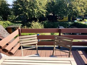 two wooden benches sitting next to each other at Haus 1795 Specht in Wustrow
