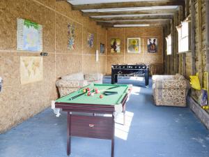 a room with a ping pong table in a room at The Old Stables in Chetnole