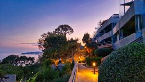 a view of a building and a street at dusk at Unique Apartment - Costa Plana in Cap d'Ail