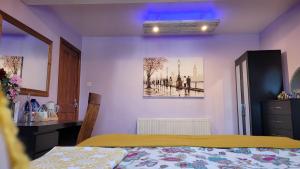 a bedroom with a bed and a painting on the wall at Another sweet home in Bradford