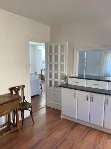 a kitchen with white cabinets and a table in a room at Villa Eugenia in La Herradura