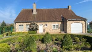 a brick house with a brown roof at Villa Lucienne in Comines